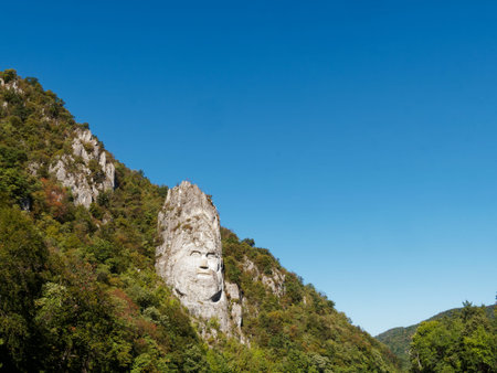Mountain landscape with  statue on top and blue skyの写真素材
