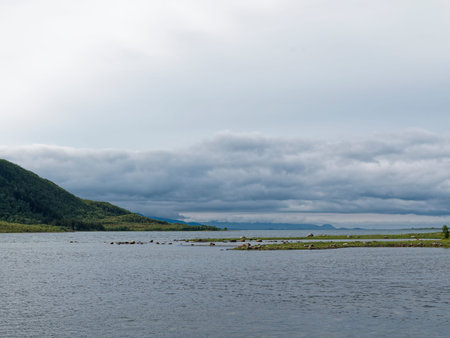 Landscape with lake, mountains and cloudy sky. Nature composition.の写真素材