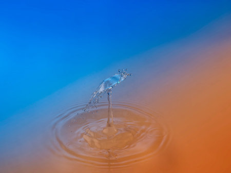 Falling drops of water. Splash effect after collision a falling drops with water Surfaceの写真素材