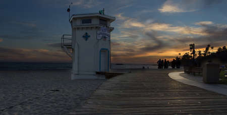 Panoramic view of the boardwalk at Main beach in Laguna Beach Southern California at sunsetの写真素材