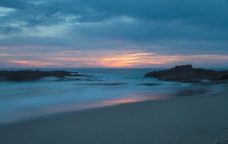 Long exposure of rocks in waves, giving a mist like effect over ocean in Laguna Beach, Californiaの写真素材