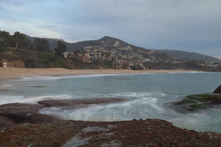 Long exposure of rocks in waves, giving a mist like effect over ocean in Laguna Beach, Californiaの写真素材