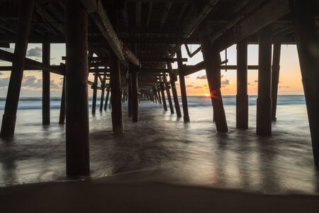 Under the San Clemente pier at sunset in the fallの写真素材
