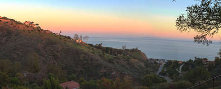Malibu hillside at sunset above the Pacific Ocean coastline in California, United States.の写真素材