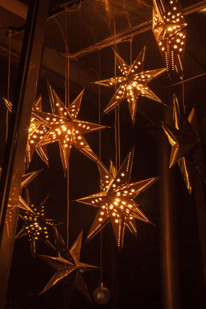 Hanging star lantern light background during the holiday seasonの写真素材