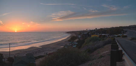 Cottages along Crystal Cove Beach, on the Newport Beach and Laguna Beach line in Southern California at sunset with a rainstorm looming.の写真素材