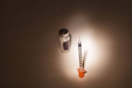 Insulin needle ready for injection in a medical doctors office in the emergency room.の写真素材