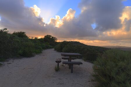 View before sunset from the top of the hiking trail at Alta Laguna Park, Top of the World, overlooking the picnic benches and saddleback mountains in Laguna Beach, Southern Californiaの写真素材