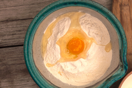 Bread making series.  Four cups of flour and egg in a bowl, three fourths of a teaspoon of cardamom...