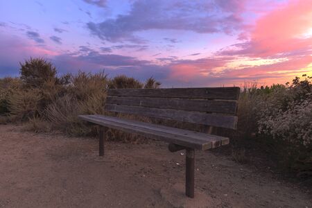 Boardwalk bench at Crystal Cove beach at sunset in the summerの写真素材