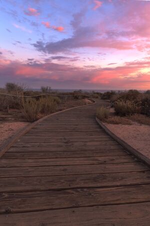 Boardwalk at Crystal Cove beach in California at sunset in the summer