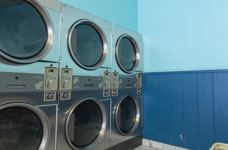 Washing clothes and drying   dryer units along the isle and walls.の写真素材