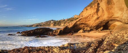 Blue sky over the coastline of One Thousand Steps Beach with tidal pools and cliffs in Laguna Beach, California, USAの写真素材