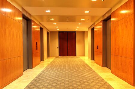 Polished, high end up and down elevator hallway in a corporate business building.