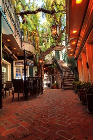 Laguna Beach, CA, USA, March 26, 2017: Garden courtyard with seating and plant life outside the...