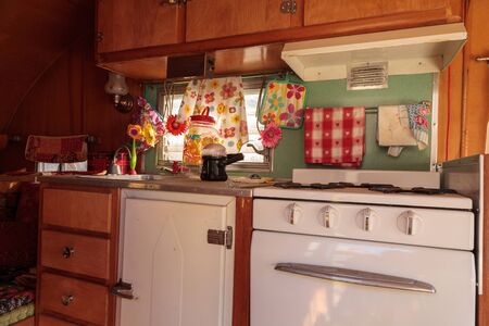Small retro caravan camper used as a tiny house on road trips to the mountains and the beach on the...