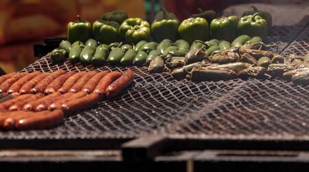 Sausage on a barbecue to cook at a fair ground in summerの写真素材