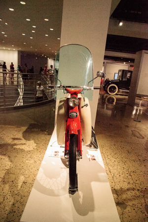 Los Angeles, CA, USA - July 23, 2017: Orange 1961 Honda 50 motorcycle displayed at the Petersen Automotive Museum. Editorial use.のeditorial素材