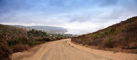 Dark rain clouds over the coastline of Laguna Beach, California, from the Laguna Coast Wilderness Park in summer.の写真素材