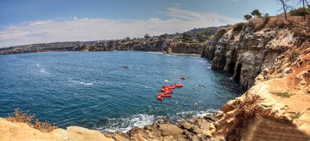 Kayaks near coastal caves at La Jolla Cove in Southern California in summer on a sunny dayの写真素材
