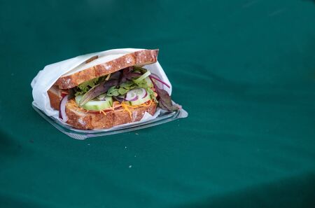 Vegetable sandwich made with Healthy mixed greens and cheese served at a farmers marketの写真素材