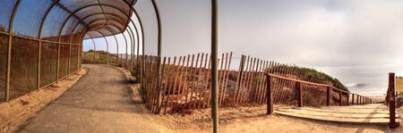 Walkway above the ocean at Crystal Cove state beach on the edge of Laguna Beach and Corona del Mar,...
