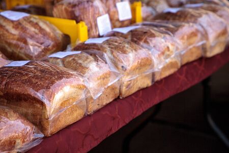 Line of freshly baked homemade bread at a farmers marketの写真素材