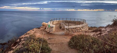 Sunset in a stone overlook that views Crystal Cove State Park Beach in Fall near Newport Beach, Californiaの写真素材