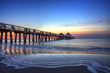 Naples Pier on the beach at sunset in Naples, Florida, USAの写真素材