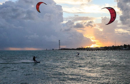 Silhouette of a Kite surfer in the ocean along the coast of southern Florida at sunset.の写真素材
