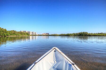 Kayak glides through water along the coastline of Marco Island, Florida near Tigertail Beach.