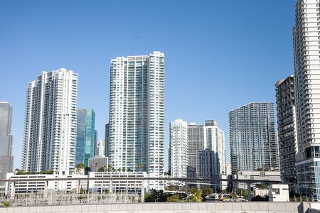 Skyline of Miami, Florida along the highway in the thick of the city with high-rise buildings and...