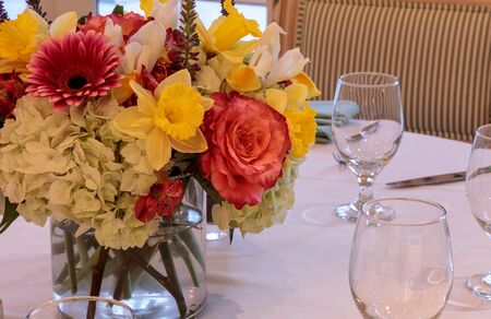 Spring bouquet of pink Gerbera daisies, yellow daffodils, orange roses, and green hydrangea on a...