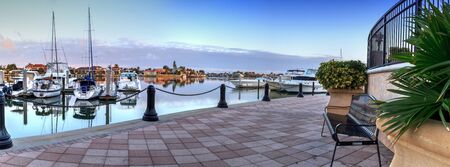 Sunrise over the boats in Esplanade Harbor Marina in Marco Island, Floridaの写真素材