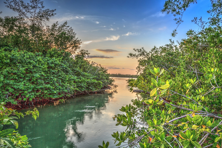Waterway that leads to the ocean on Isle of Capri near Marco Island, Florida at Sunset.の写真素材