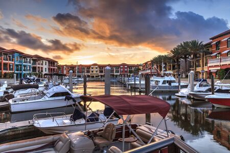 Naples, Florida, USA â May 29, 2019: Colorful buildings and a harbor of boats along a waterway in Naples, Florida.の写真素材
