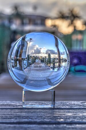 Crystal ball of Boats docked at a Marina near Venetian Bay in Naples, Florida at sunrise.の写真素材