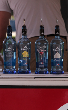 Naples, Florida, USA â October 26, 2019: Vodka bottles line up at an outside bar at a festival.のeditorial素材