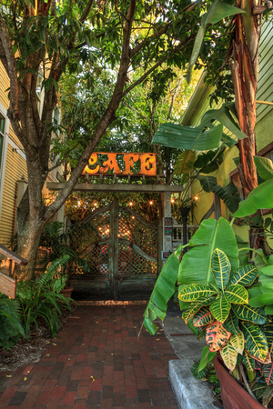 New Smyrna Beach, Florida, USA â November 2, 2019: Third Wave Cafe courtyard entrance at sunrise with lights and a tranquil jungle environment in New Smyrna Beach, Florida.のeditorial素材