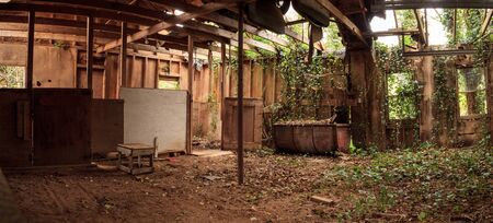 Run down dilapidated horse barn on an abandoned farm in New England.の写真素材
