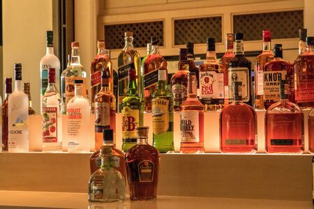 Naples, Florida, USA - November 3, 2018: Selection of colorful liquor alcohol bottles line the shelf...