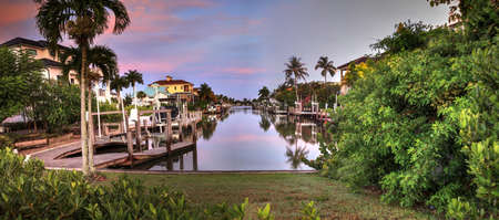 Sunrise over a Waterway leading to the Ocean near Vanderbilt Beach in Naples, Florida.のeditorial素材