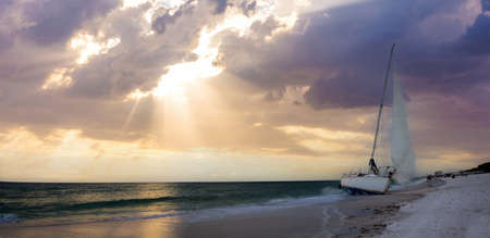 Sunset over shipwreck on the coast of Clam Pass in Naples, Floridaの写真素材