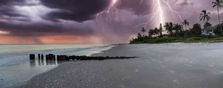 Lightning storm over the ocean at Port Royal Beach in Naples, Florida at sunrise.の写真素材