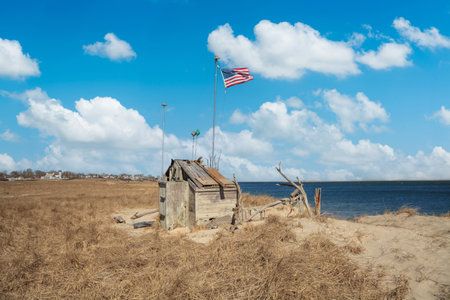 Wooden well on the beach with the American flag in the backgroundの写真素材