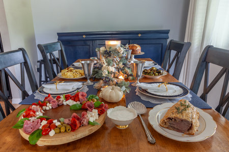 Loaded gourmet holiday table with fine bone China at Christmas.の写真素材
