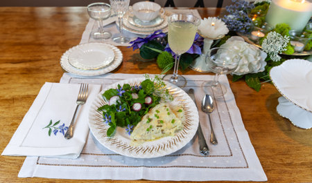 Cod fish and spring green salad on fine China with a table decorated for Easter.の写真素材
