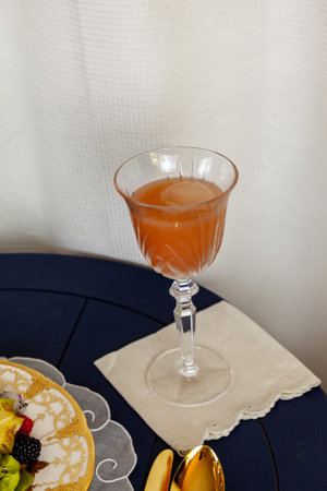 Grapefruit juice mimosa in a crystal glass with a ball of iceの写真素材