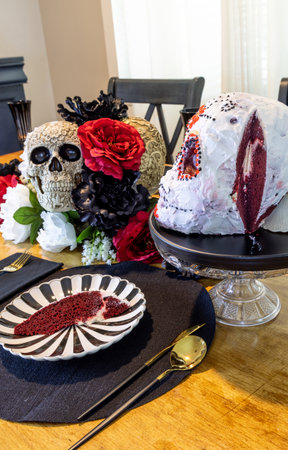Red Velvet cake in the shape of a decorated skull on an All Saints Day decorated table.の写真素材