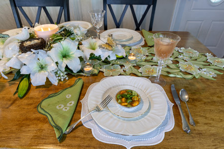Green kiwi berry, grape and kumquat tart with passion fruit curd on a cookie crust on a plate and silverware.の写真素材